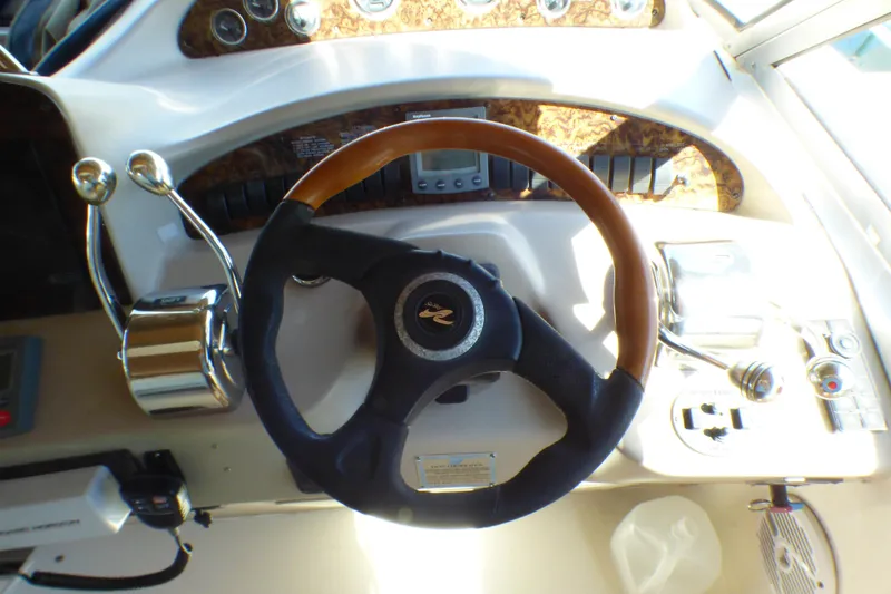 Steering wheel and controls of a 2002 Sea Ray 340 Sundancer boat cockpit.