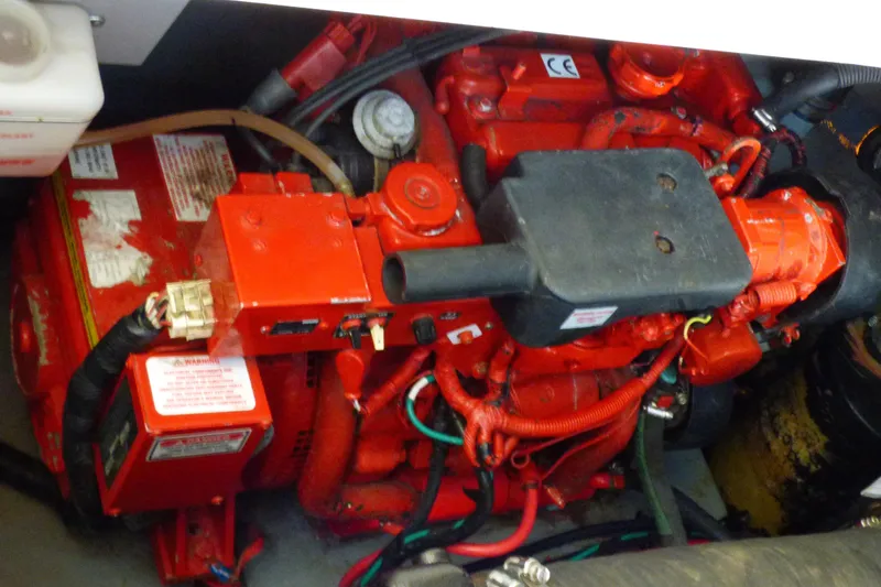 Engine compartment of a 2002 Sea Ray 340 Sundancer boat, featuring red components.