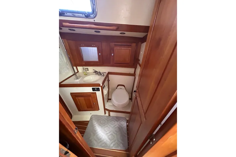 2003 Tartan 4400 LS yacht bathroom with wooden cabinetry and compact design.