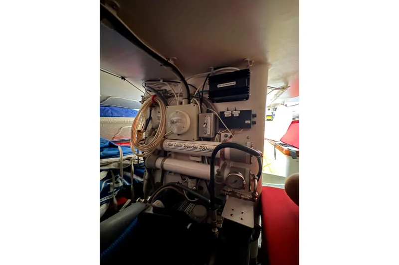 Interior of 1999 Laurie Davidson TP-52 yacht, showcasing mechanical equipment and wiring.