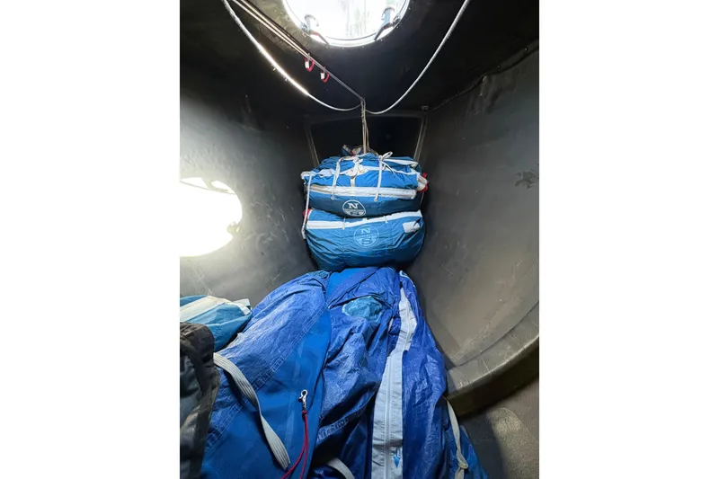 Interior of 1999 Laurie Davidson TP-52 sailboat with blue sails stored.