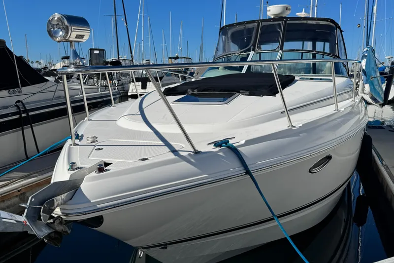 2006 Chaparral Signature 350 boat docked in a marina under clear blue skies.