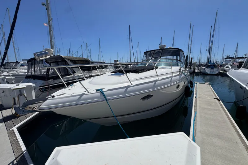 2006 Chaparral Signature 350 yacht docked at marina under clear blue sky.
