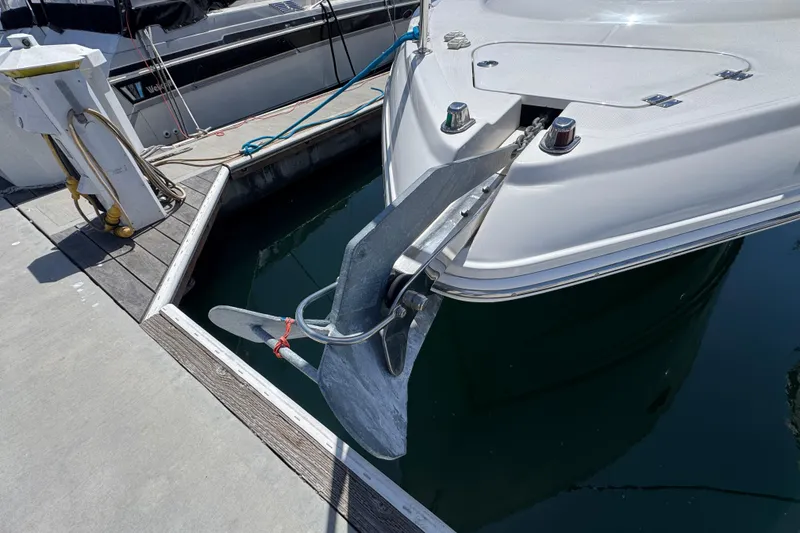 Bow of a 2006 Chaparral Signature 350 yacht with anchor at marina dock.