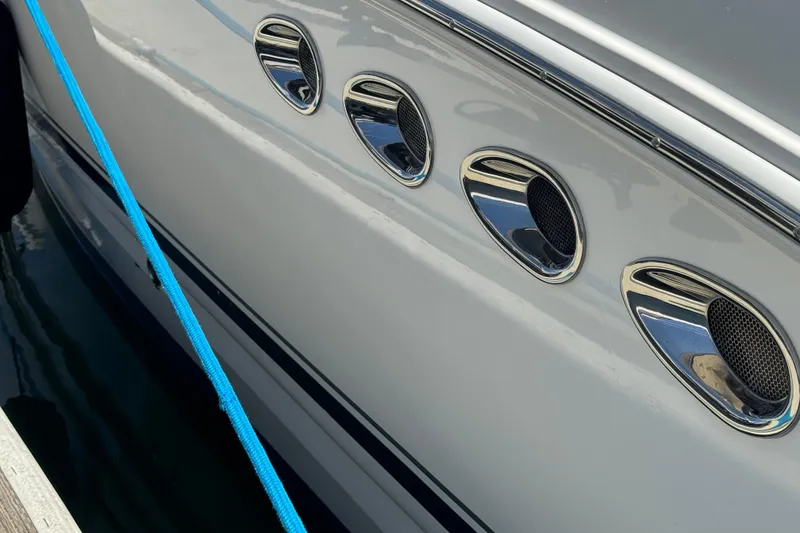 Close-up of 2006 Chaparral Signature 350 boat with chrome vents and blue rope.