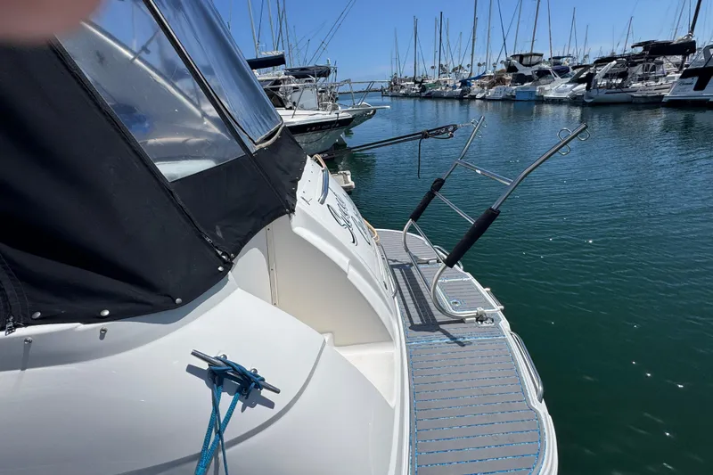 2006 Chaparral Signature 350 yacht docked in a marina with other boats.