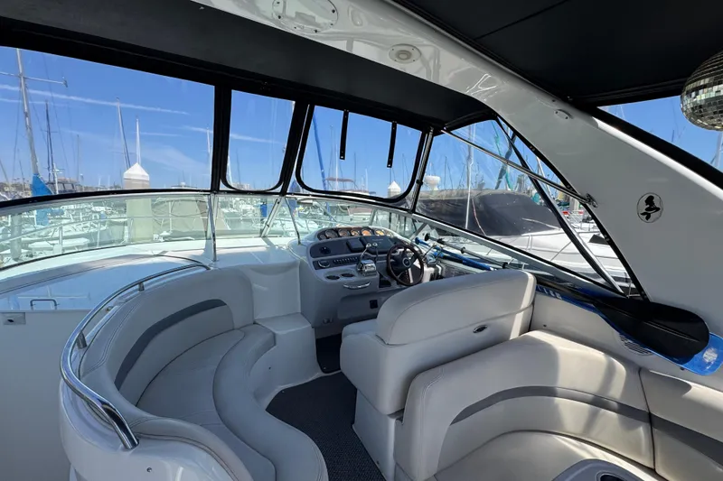 Interior view of 2006 Chaparral Signature 350 yacht with helm and seating area.