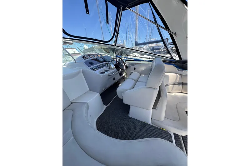 Interior of 2006 Chaparral Signature 350 boat with white seating and control panel.