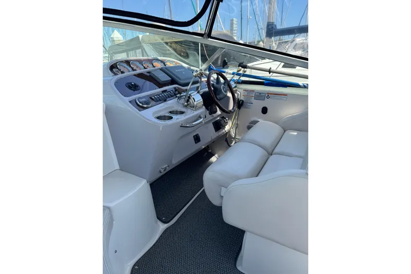 2006 Chaparral Signature 350 boat cockpit with steering wheel and control panel.