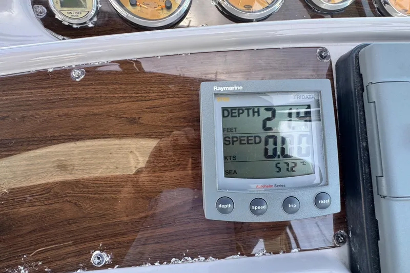 Control panel of 2006 Chaparral Signature 350 boat with Raymarine display showing depth and speed.