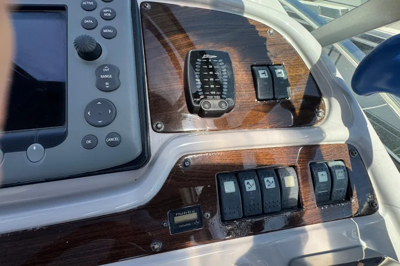 Control panel of a 2006 Chaparral Signature 350 boat with switches and navigation controls.