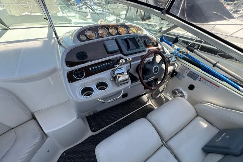 2006 Chaparral Signature 350 boat cockpit with steering wheel and control panel.