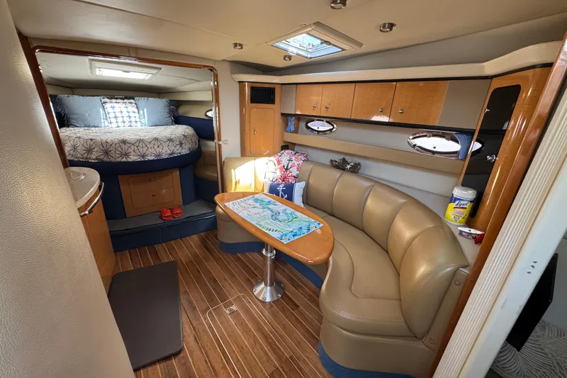 Luxurious 2006 Chaparral Signature 350 yacht interior with cozy seating and elegant wood finishes.