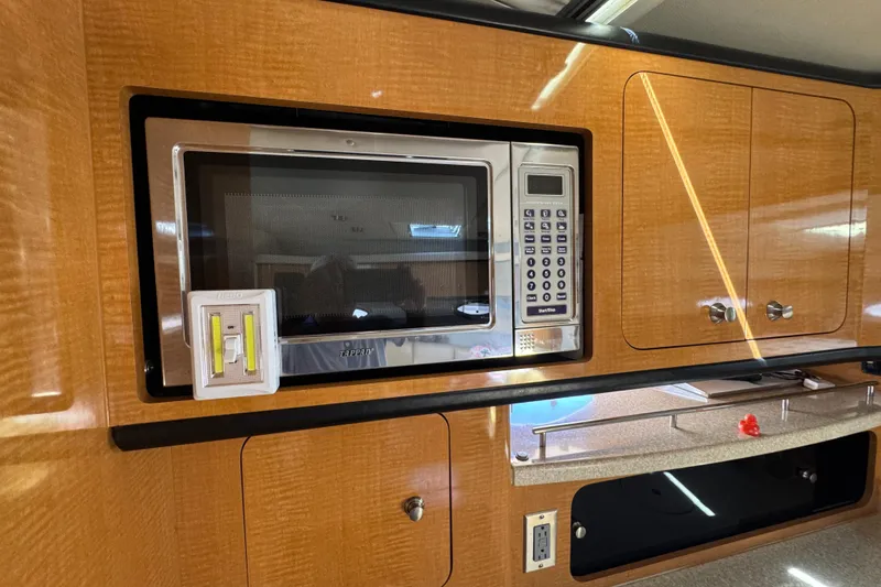 2006 Chaparral Signature 350 interior with microwave and wooden cabinetry.