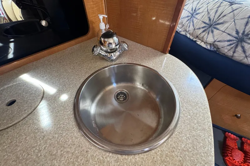 2006 Chaparral Signature 350 boat interior with stainless steel sink and countertop.