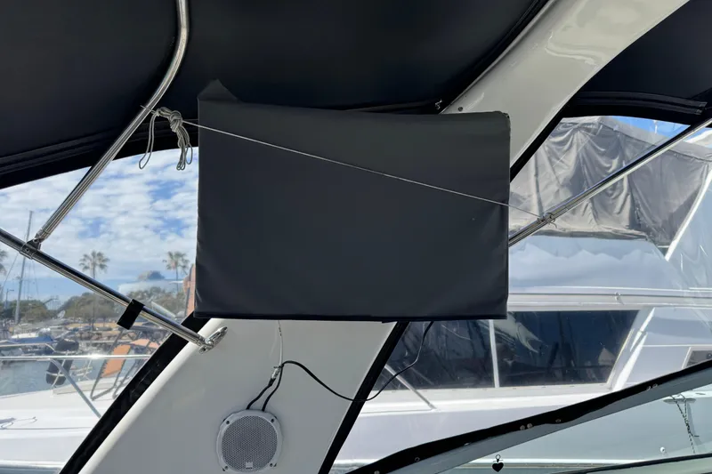 2006 Chaparral Signature 350 boat interior with covered equipment and marina view.