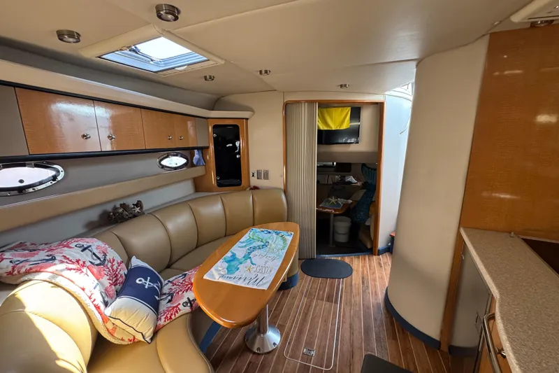 Interior of 2006 Chaparral Signature 350 yacht with cozy seating and wooden accents.