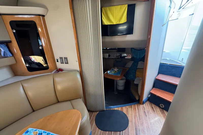 Interior of 2006 Chaparral Signature 350 yacht with seating, table, and stairs.