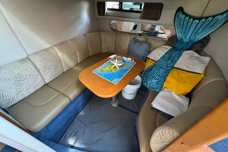 Interior of 2006 Chaparral Signature 350 boat with cozy seating and nautical decor.