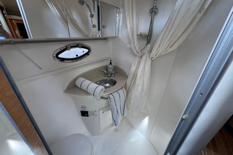 Bathroom interior of 2006 Chaparral Signature 350 yacht with sink and shower.