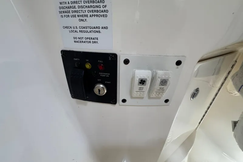 Control panel on a 2006 Chaparral Signature 350 boat with discharge and lighting switches.