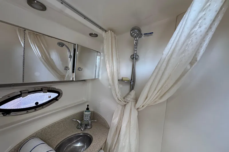 Bathroom interior of 2006 Chaparral Signature 350 yacht with shower and sink.
