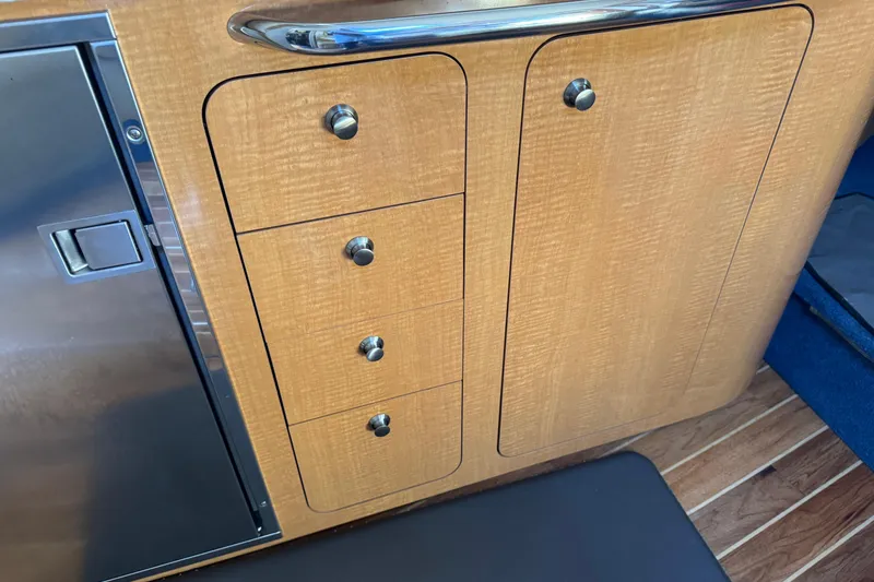 2006 Chaparral Signature 350 interior with wooden cabinets and stainless steel accents.