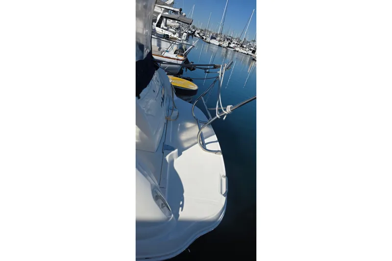 2005 Sea Ray 340 Sundancer docked at marina, calm water reflection.