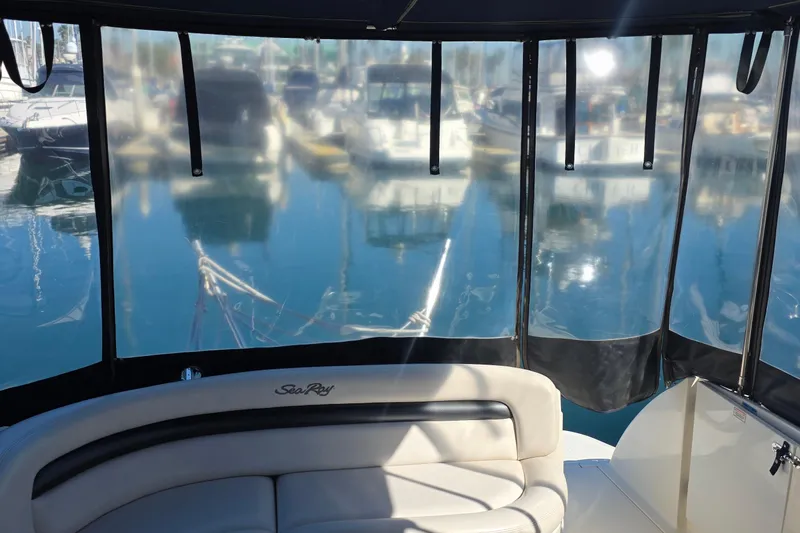 2005 Sea Ray 340 Sundancer interior with marina view through clear panels.