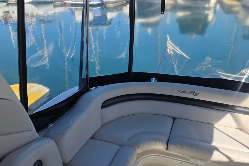 Interior view of 2005 Sea Ray 340 Sundancer boat with marina backdrop.