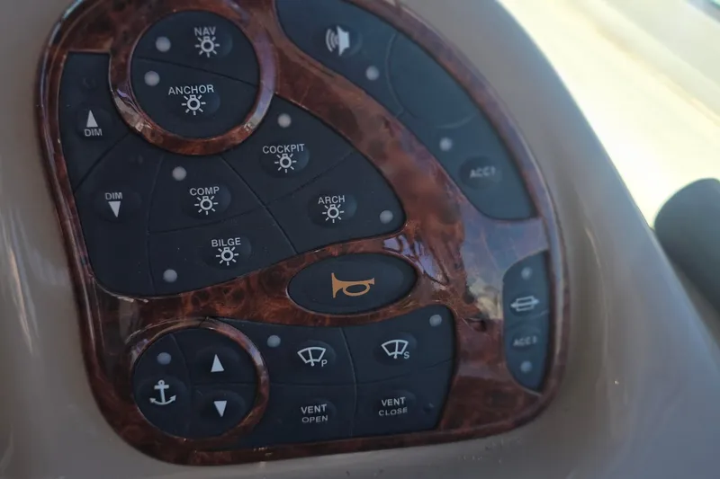 Control panel of a 2005 Sea Ray 340 Sundancer boat with various function buttons.