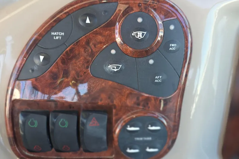 Control panel of a 2005 Sea Ray 340 Sundancer boat with wood finish.