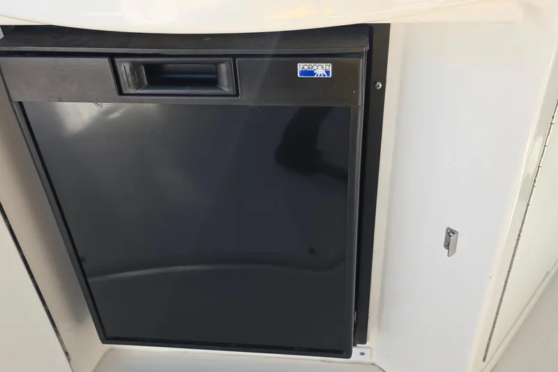 Norcold refrigerator on 2005 Sea Ray 340 Sundancer boat, black door, compact design.