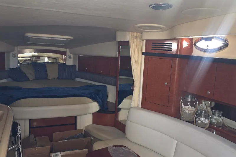 Interior of 2005 Sea Ray 340 Sundancer yacht with cozy seating and elegant wood cabinetry.