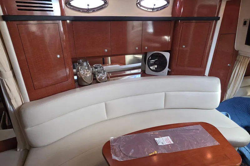 Interior of 2005 Sea Ray 340 Sundancer with elegant seating and wooden cabinetry.