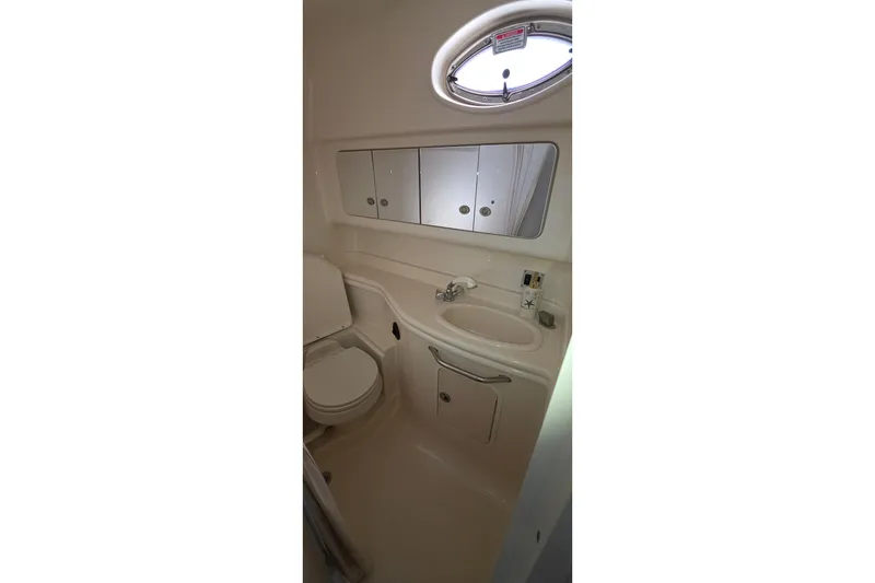 Bathroom interior of 2005 Sea Ray 340 Sundancer yacht, featuring sink and toilet.