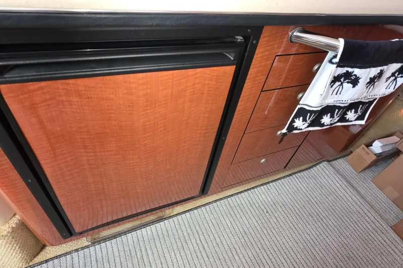 2005 Sea Ray 340 Sundancer interior with wood cabinetry and towel rack.
