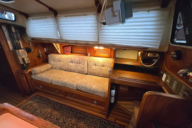 Interior of 1979 Islander Freeport 36 sailboat with cozy seating and wooden accents.