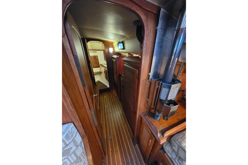 Interior view of 1979 Islander Freeport 36 sailboat, featuring wood paneling and compact design.