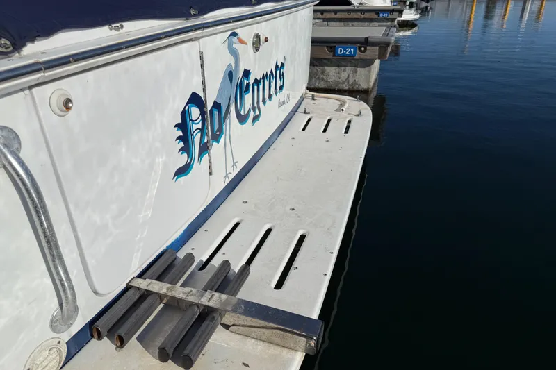 1998 Luhrs Tournament 320 Convertible boat docked, featuring "No Egrets" graphic on the side.