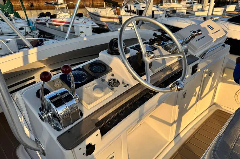 1998 Luhrs Tournament 320 Convertible boat helm with steering wheel and control panel.