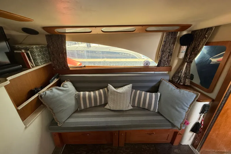 Interior of 1998 Luhrs Tournament 320 Convertible with cozy seating and decorative pillows.