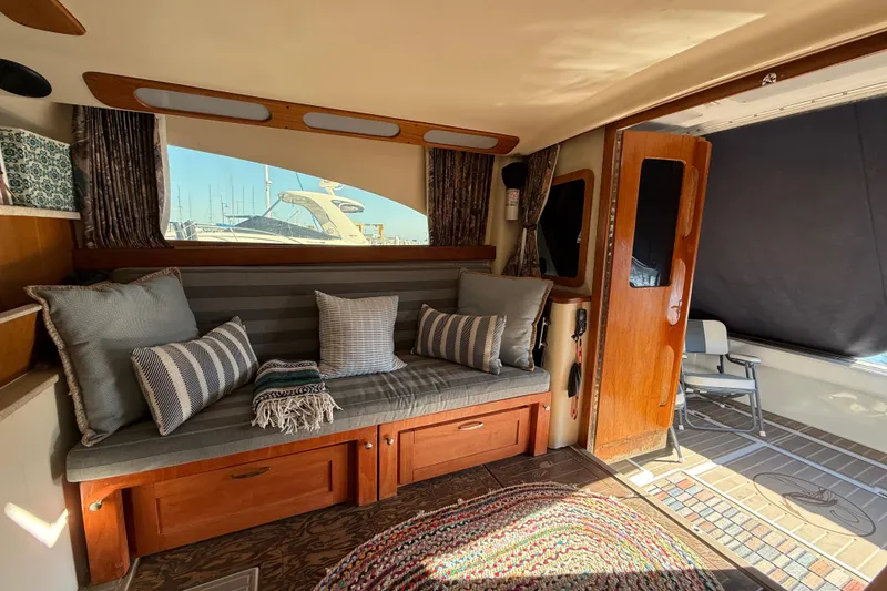 Interior of 1998 Luhrs Tournament 320 Convertible with cozy seating and nautical decor.