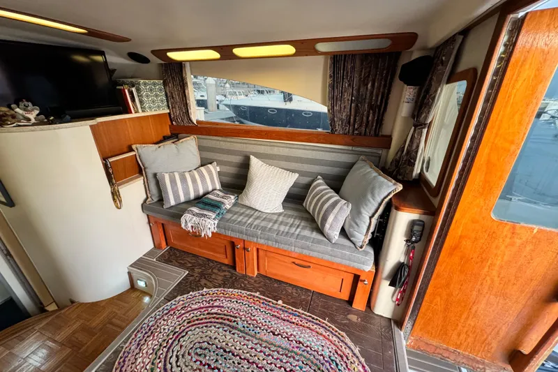 Interior of 1998 Luhrs Tournament 320 Convertible with cozy seating and decorative pillows.