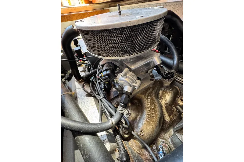 Engine of 1998 Luhrs Tournament 320 Convertible boat, showcasing intricate mechanical components.