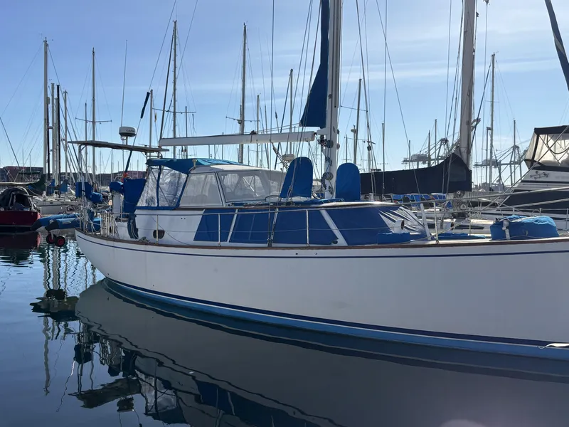 1973 CAL 246 sailboat docked in a marina, surrounded by other boats.