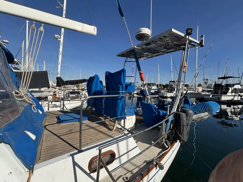 1973 CAL 246 sailboat docked in marina, featuring blue covers and solar panel.