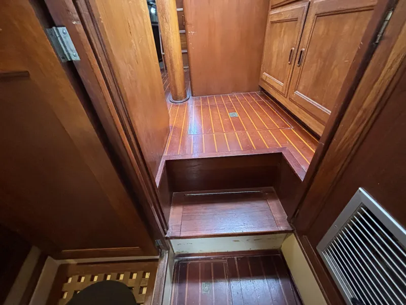 Interior of a 1973 CAL 246 boat with wooden flooring and cabinetry.