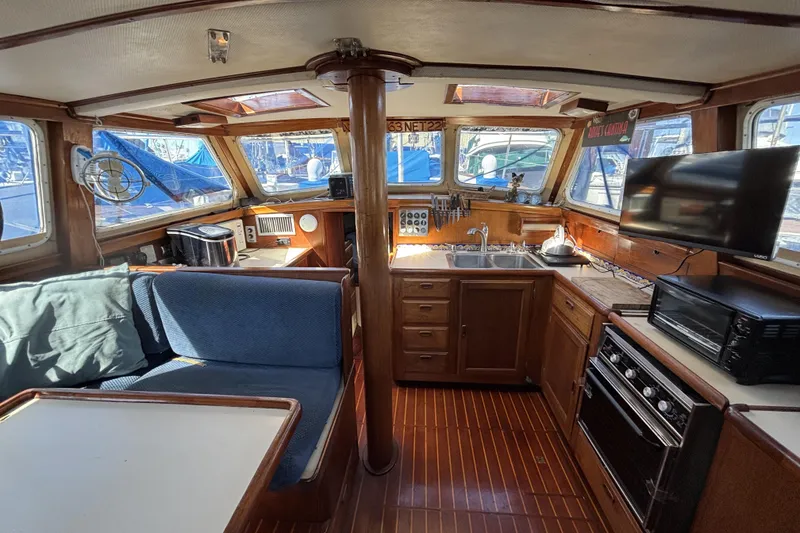 1973 CAL 246 yacht interior with kitchen, seating, and navigation equipment.