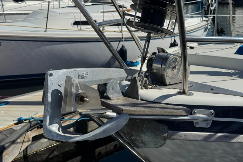 Anchor and winch system on a 1988 Gulf Pilot House boat at a marina.